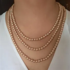 Estele gold pearl three layered necklace